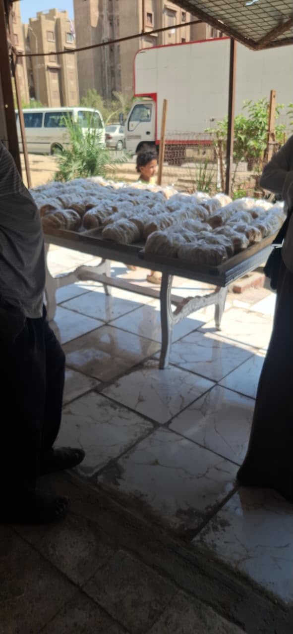 Long tables covered with individually bagged loaves of bread, ready for the morning's distribution.